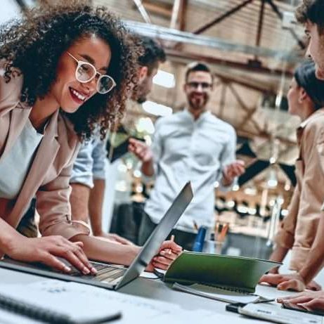 Group of young multiracial business people are working in modern office. Freelancers in coworking place. Creative and stylish youth.