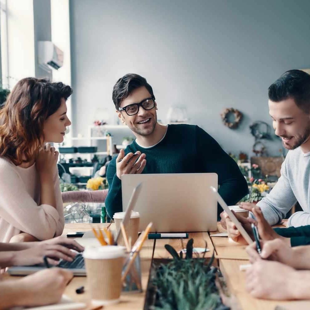 Marketing apprentices A group of young digital professionals are sitting around a conference table discussing ideas